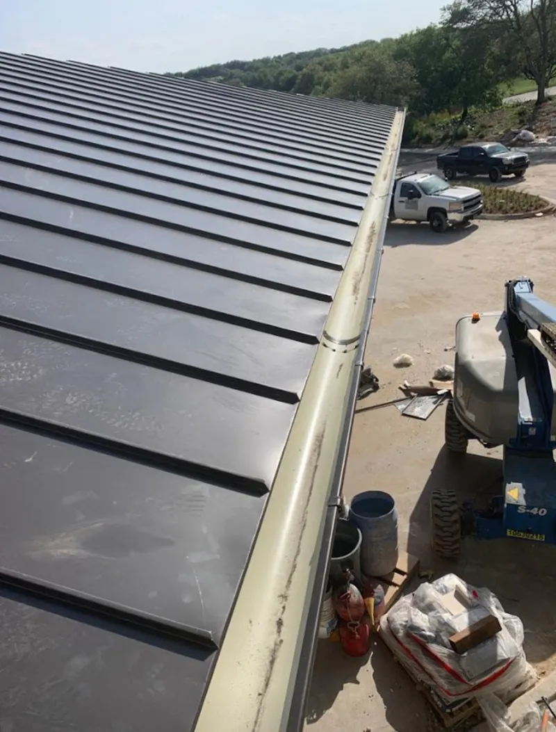 Standing seam panel and gutter detail on a metal roofing jobsite in Elko New Market